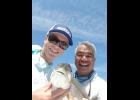 Tristin Poole poses with Captain Greg Peralta and one of the few fish the pair caught on Sunday.