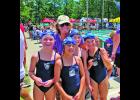 City Meet 7-8 girls free relay champions Willa LeVeen, Sarah Ligon, Charlotte Good and Lilah May pose with Flying Fish head coach Rose Van Metre. 